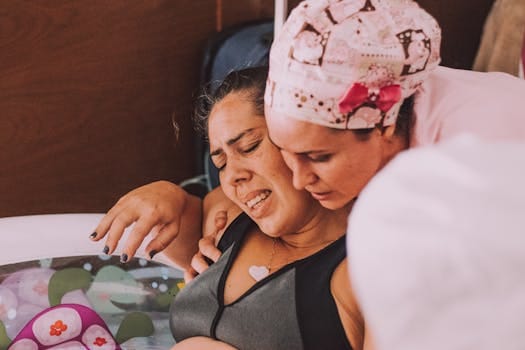 Journey of Motherhood: A Lifetime of Love, Sacrifice, and Strength 3 A midwife comforts a pregnant woman during a water birth at home.