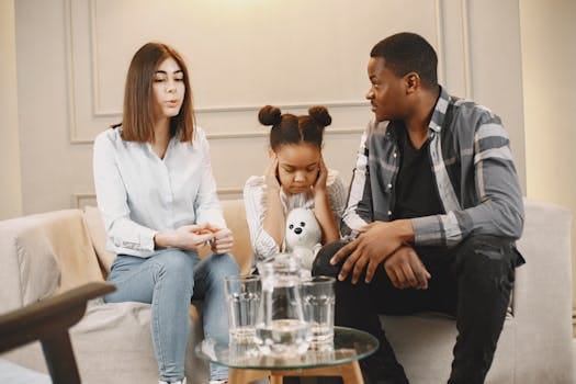 Parenthood Reshapes Married Life: Why Having Kids Strengthens Your Relationship? 4 Parents talking to daughter covering ears on sofa.