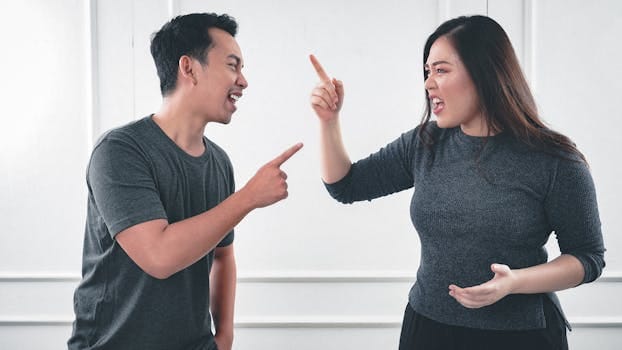 9 Habits of an Immature Wife That Damage Marriage 4 A couple engaged in a heated argument at home, expressing strong emotions.