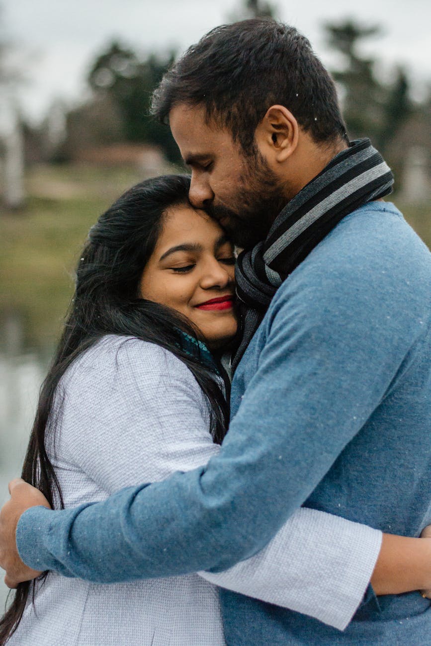 The Importance of Apologizing in Relationships: Why Saying Sorry Matters? 4 man in blue kissing woman on forehead