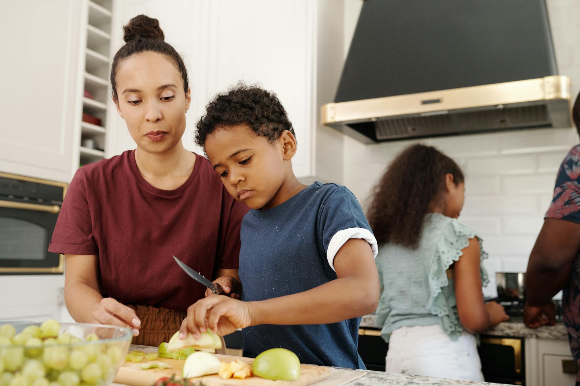 30 Powerful Ways to Show Gratitude to Parents 6 a mother teaching her son how to slice a fruit