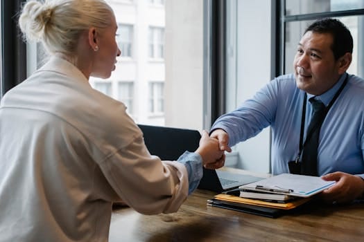Living with Values That Outlast You: What Will People Remember You For? 4 Two professionals in an office setting shaking hands after a business agreement.