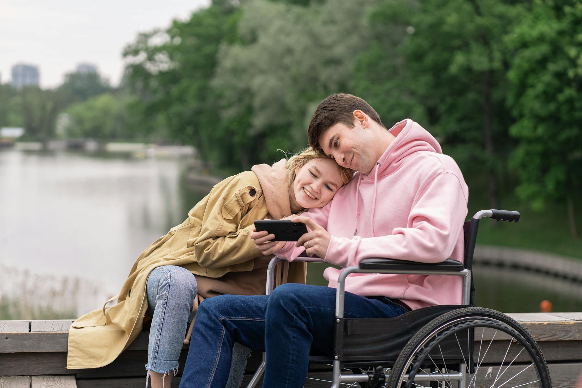 a woman and man looking the smartphone together