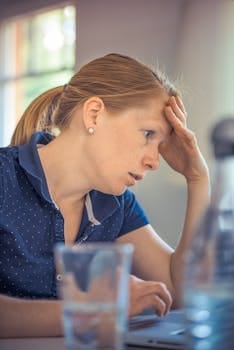 Supermom: Liberating Working Moms From The Supermom Myth 3 Businesswoman showing stress and concentration while working at her desk.