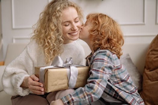 Being Grateful Brings More Joy: How Gratitude Unlocks a Happier Life 3 A joyful mother receives a kiss while holding a gift from her son indoors.