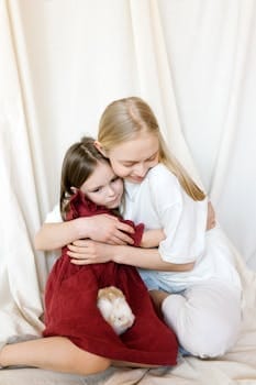 A touching moment of a mother and daughter hugging with their guinea pig.