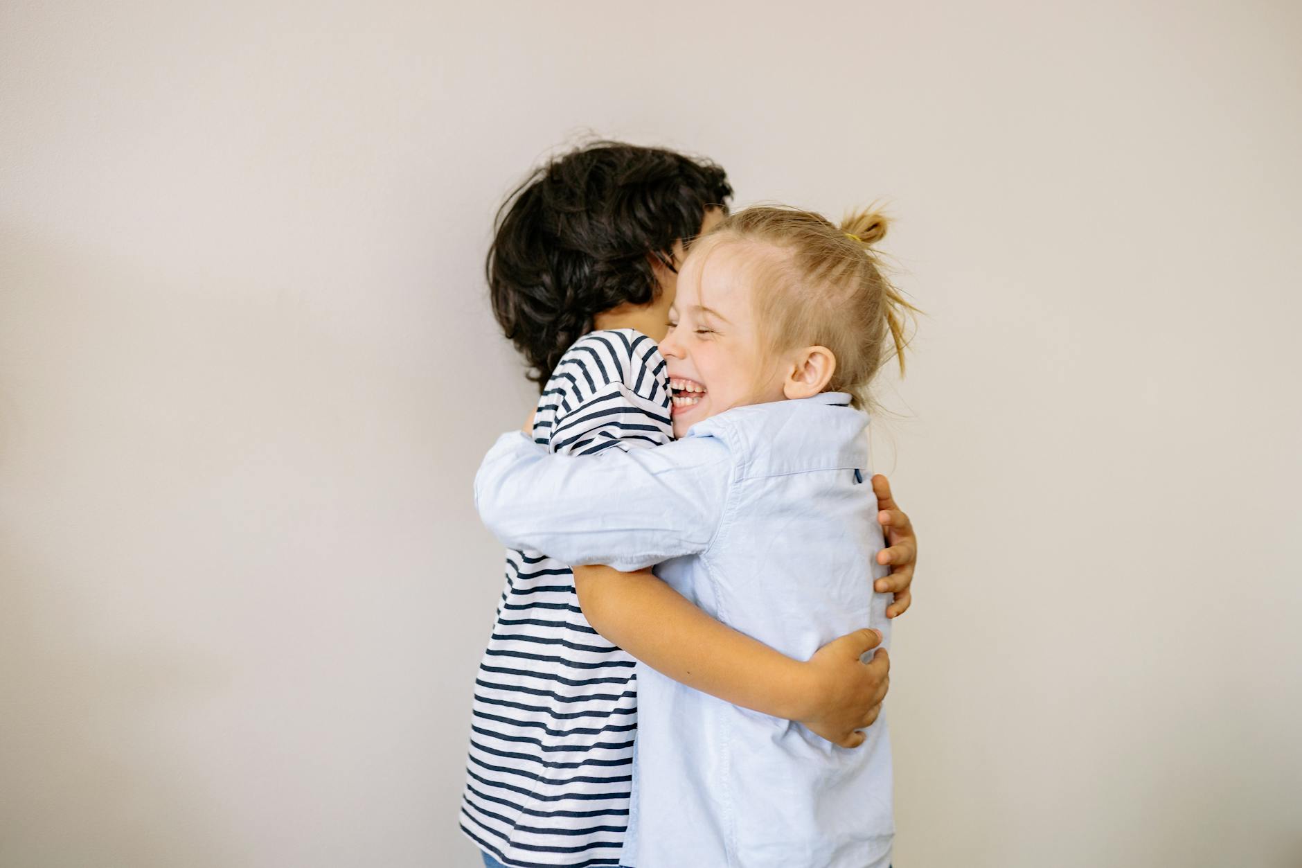 The Power of Sibling Bonds: How Brothers and Sisters Shape Emotional Strength 3 a boy and blonde girl hugging each other