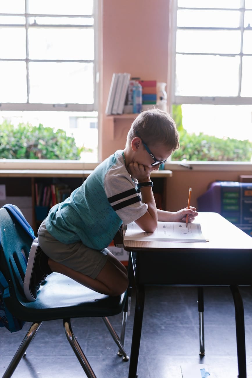 Essential Life Skills to Teach Kids: Building Confidence and Independence from Toddler to Teen 6 photo of a boy doing his homework