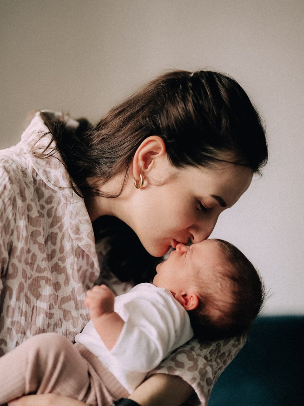 mother sharing tender moment with newborn