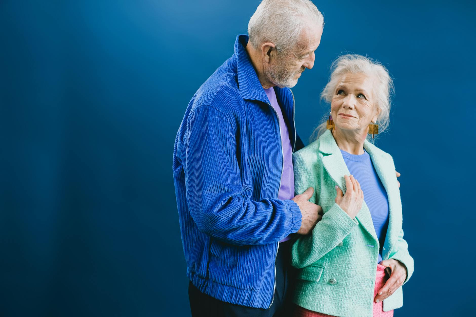 elderly man and woman looking at each other