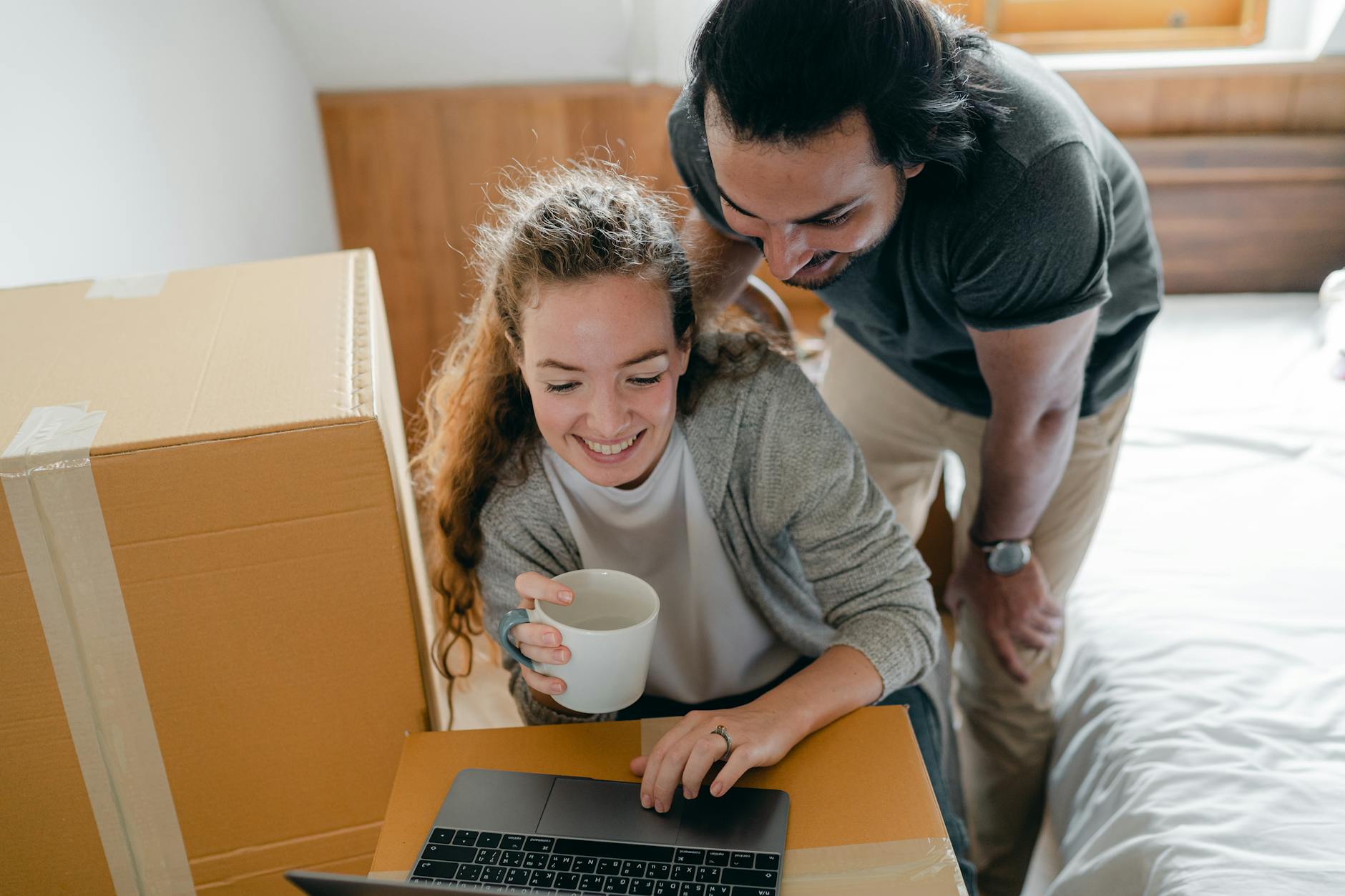 Moving Ahead From Painful Life Events | A Practical Guide to Healing and Growth 3 happy multiracial couple surfing internet on laptop while drinking coffee