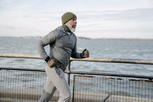 Healthy Morning Routine for Seniors | Science-Backed Habits That Add Strength, Energy, and Long Life 6 Elderly man jogging on promenade by the sea on a winter morning, showcasing active lifestyle.