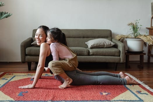Raising Emotionally Healthy Children Is Our Second Chance as Parents 3 A joyful mother practicing yoga with her daughter on a colorful rug indoors.