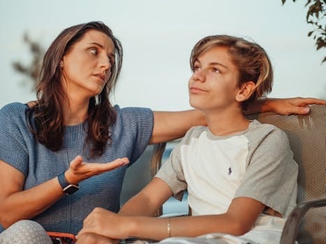Understanding Teenagers | Why Parents Feel Disconnected and How to Rebuild Trust? 3 A mother and her teenage son engage in a conversation sitting outside, expressing familial warmth and connection.